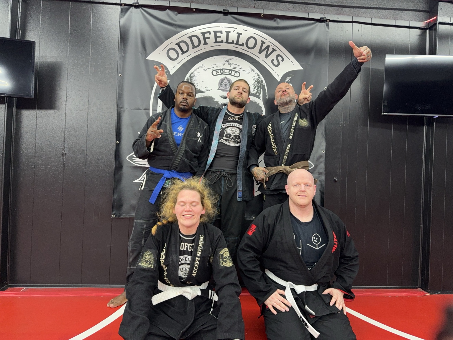 Oddfellows training partners standing together in front of the club banner