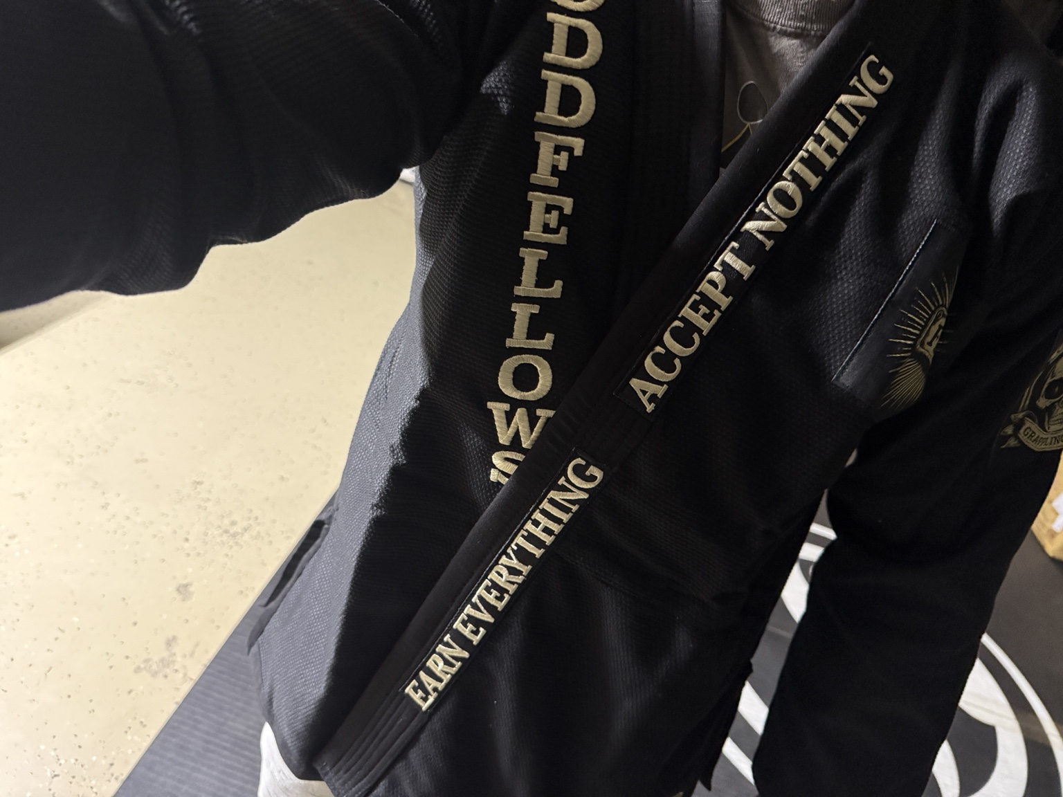 Embroidered Oddfellows lettering on a black club gi